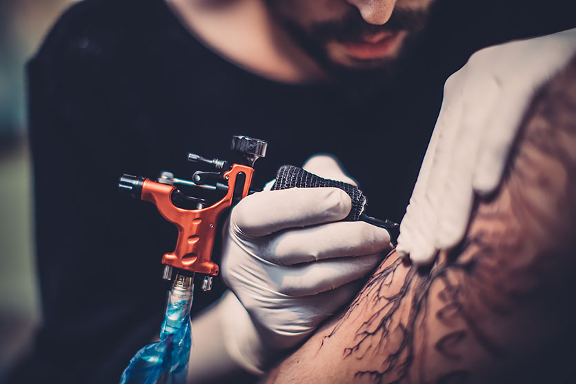 A tattoo artist working with an Ink Machines Dragonfly
